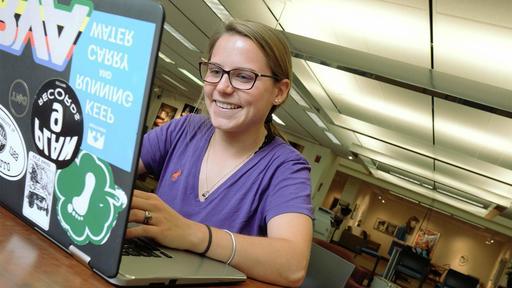 A student works on her laptop in Hege Library.